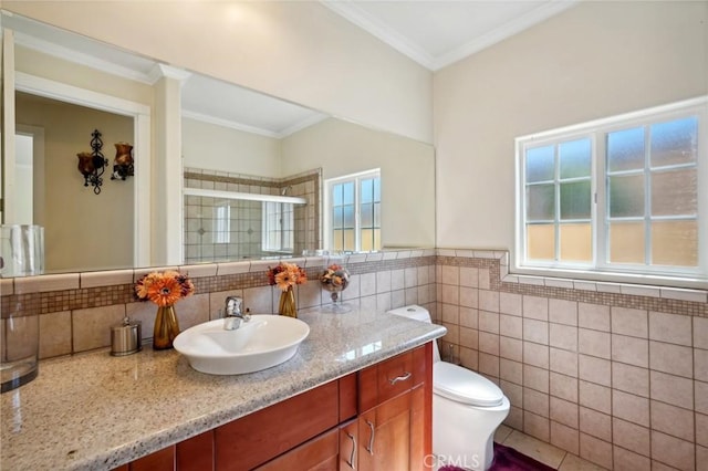 bathroom with crown molding, tile walls, vanity, a shower with shower door, and toilet