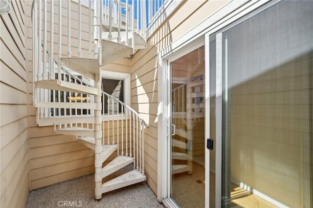 stairs featuring wooden walls