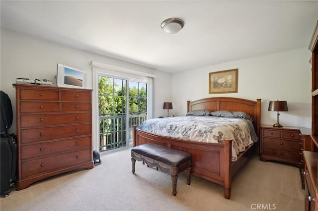 bedroom featuring access to outside and light colored carpet