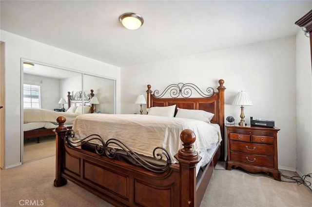 bedroom with light colored carpet and a closet