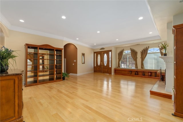 interior space with ornamental molding and light wood-type flooring