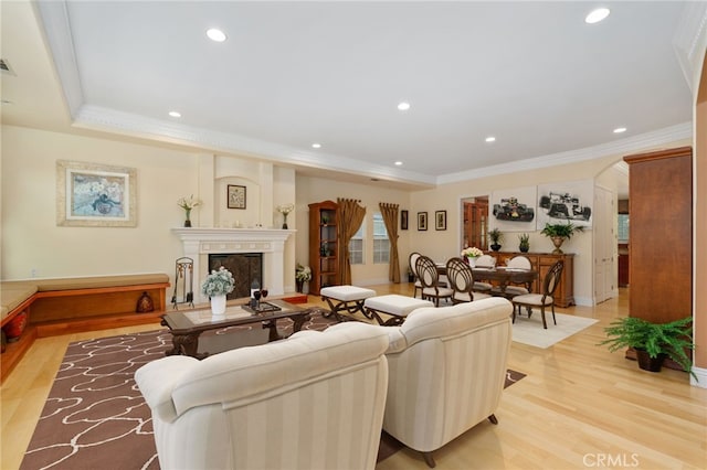 living room with ornamental molding and light hardwood / wood-style floors