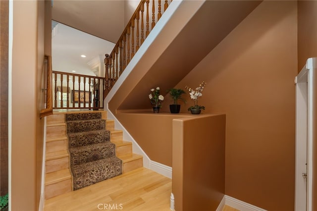 stairs with hardwood / wood-style floors