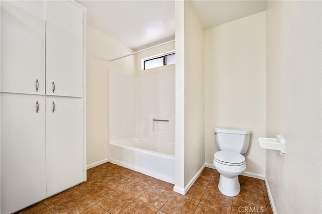 bathroom featuring tile patterned flooring, bathtub / shower combination, and toilet