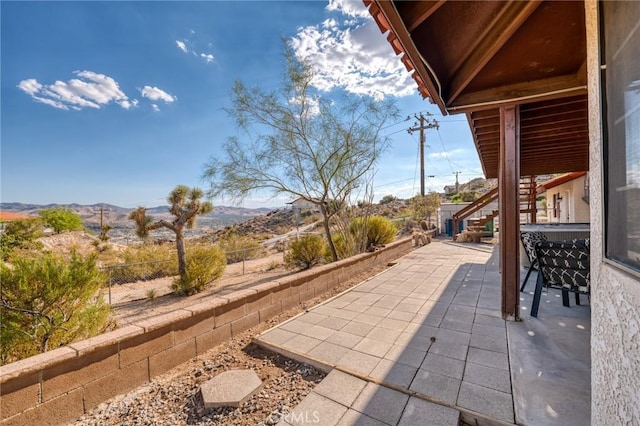 view of patio / terrace with a mountain view