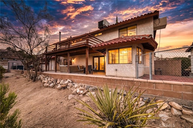 back house at dusk with a patio