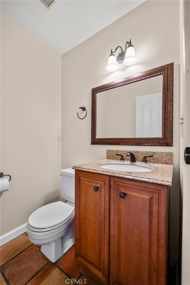 bathroom with tile patterned floors, vanity, and toilet