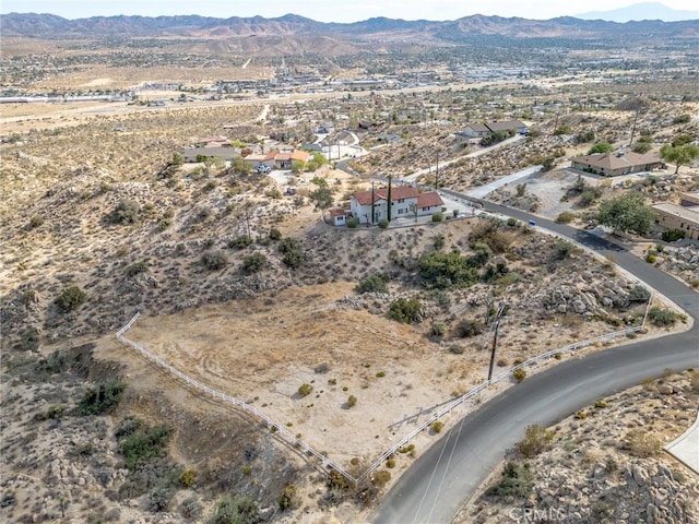 birds eye view of property featuring a mountain view