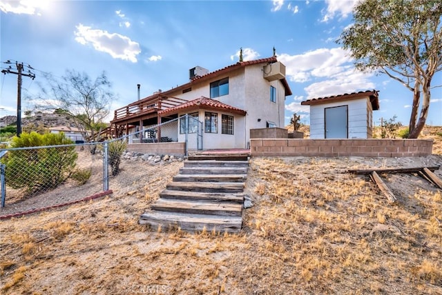 rear view of property with a wooden deck