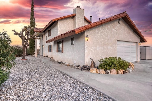 property exterior at dusk with a garage