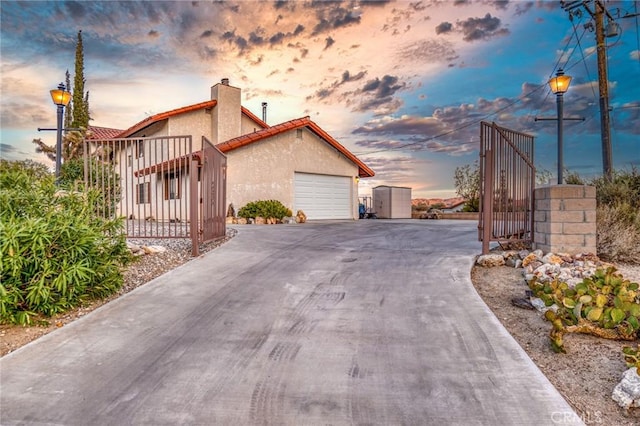 property exterior at dusk featuring a garage