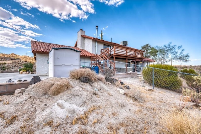 view of front of property with cooling unit and a deck