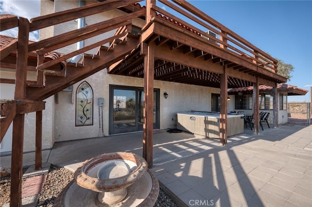 view of patio with a deck and an outdoor fire pit