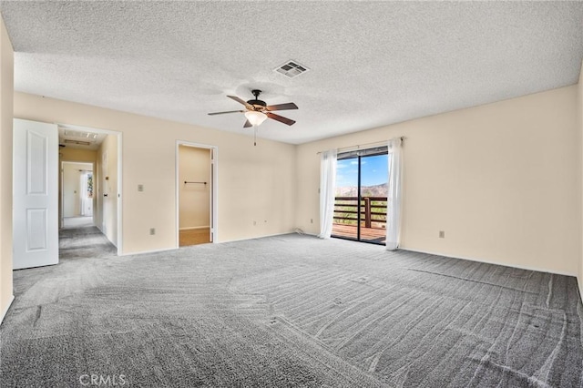 carpeted empty room featuring a textured ceiling and ceiling fan