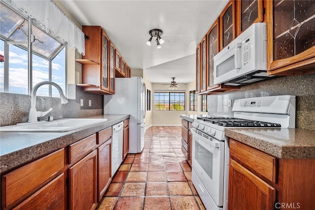 kitchen with white appliances, tasteful backsplash, ceiling fan, and sink