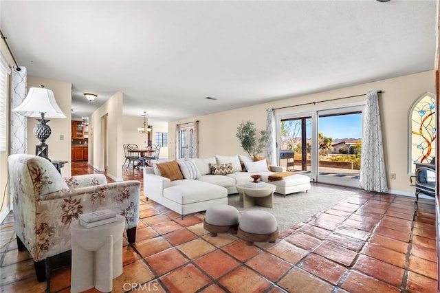 tiled living room featuring a notable chandelier