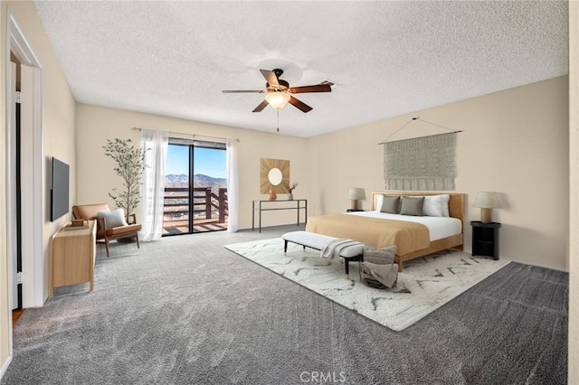 carpeted bedroom featuring access to outside, ceiling fan, and a textured ceiling