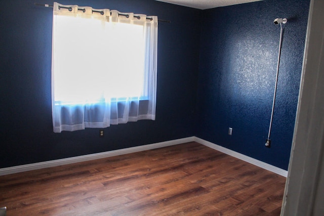 unfurnished room featuring wood-type flooring