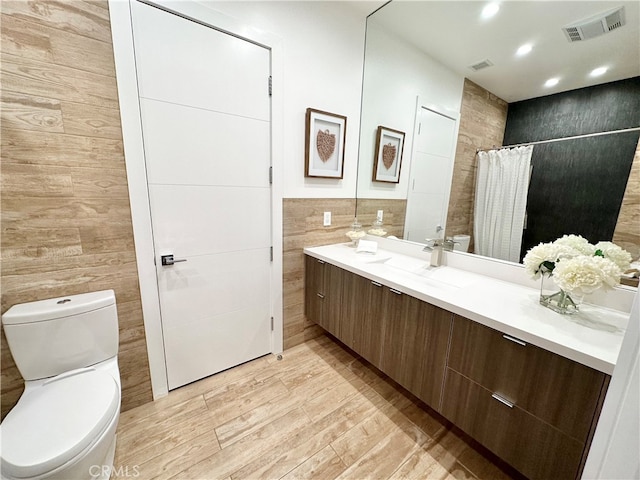 bathroom featuring vanity, toilet, a shower with curtain, and hardwood / wood-style floors