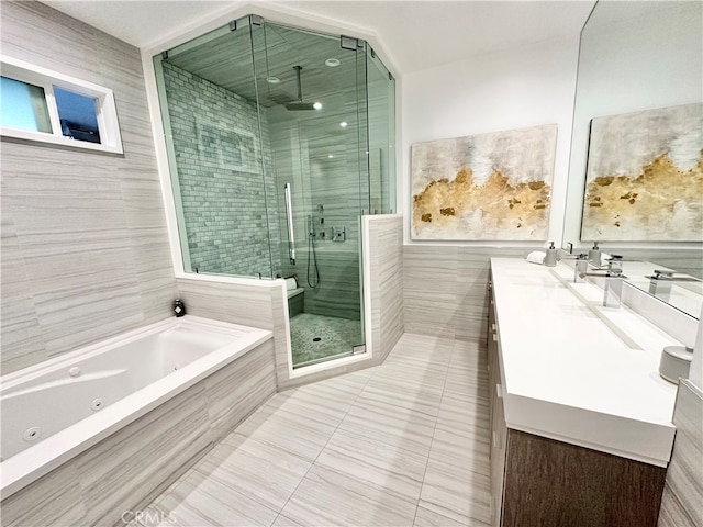 bathroom featuring vanity, tile walls, independent shower and bath, and tile patterned flooring