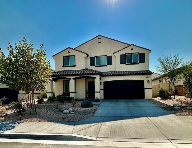 mediterranean / spanish-style home featuring a garage