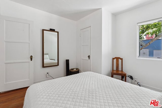 bedroom featuring dark hardwood / wood-style flooring