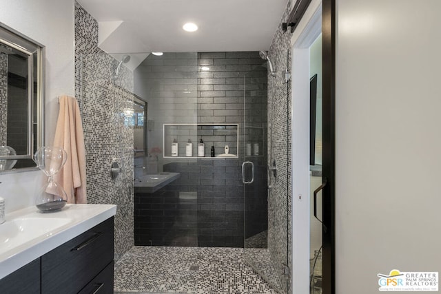 bathroom featuring vanity and a shower with shower door