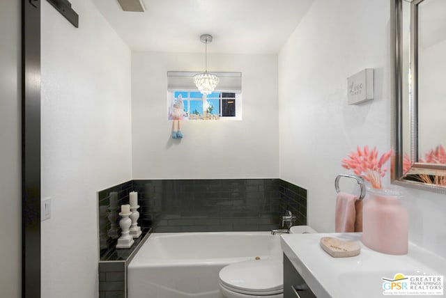 bathroom featuring vanity, a bath, toilet, and an inviting chandelier