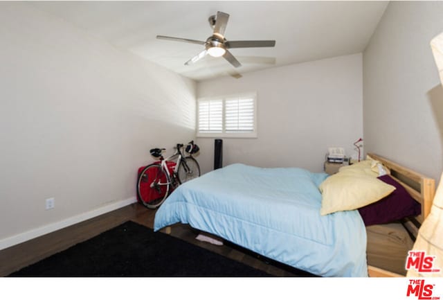 bedroom with ceiling fan and dark wood-type flooring