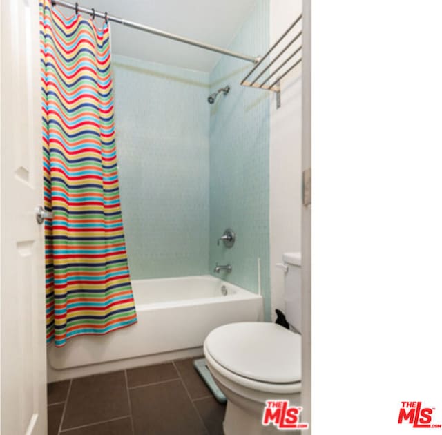 bathroom featuring tile patterned floors, toilet, and shower / bath combo