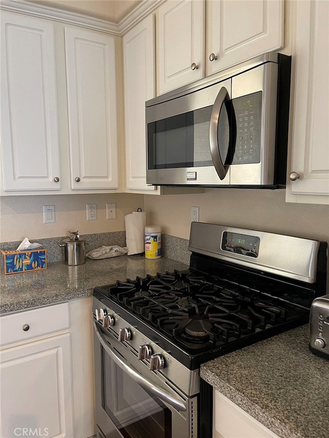 kitchen featuring stainless steel appliances and white cabinets