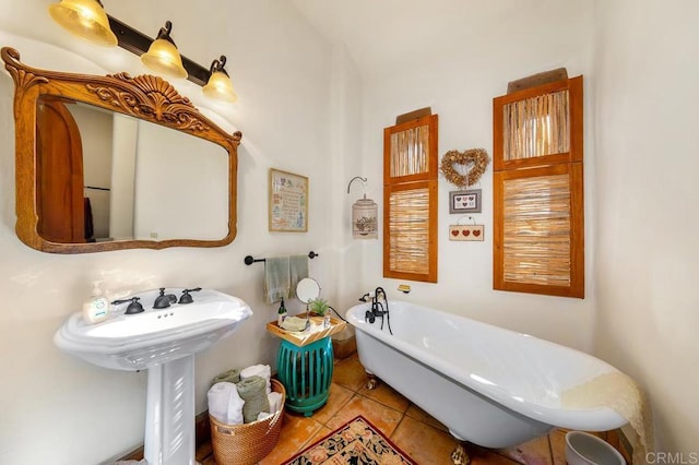 bathroom with tile patterned flooring and a washtub