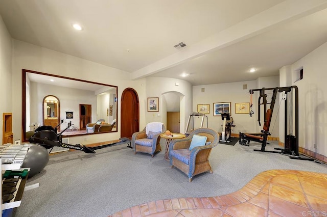 living area with carpet and beam ceiling