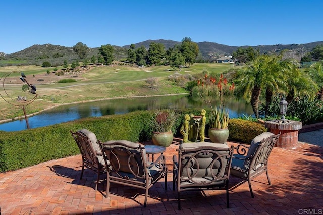 view of patio featuring a water and mountain view