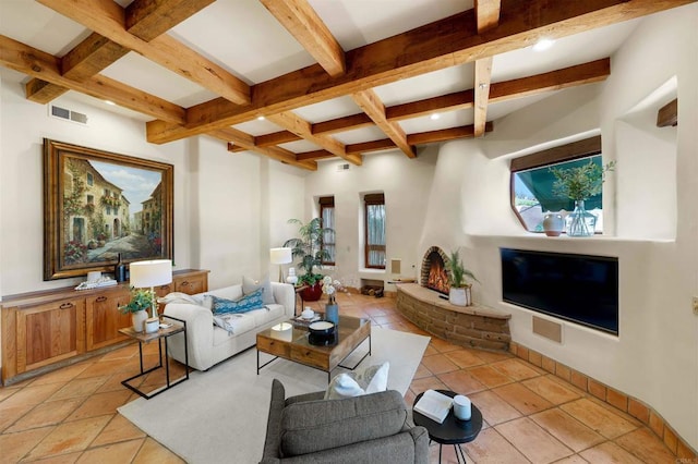 living room with light tile patterned flooring, beamed ceiling, and coffered ceiling