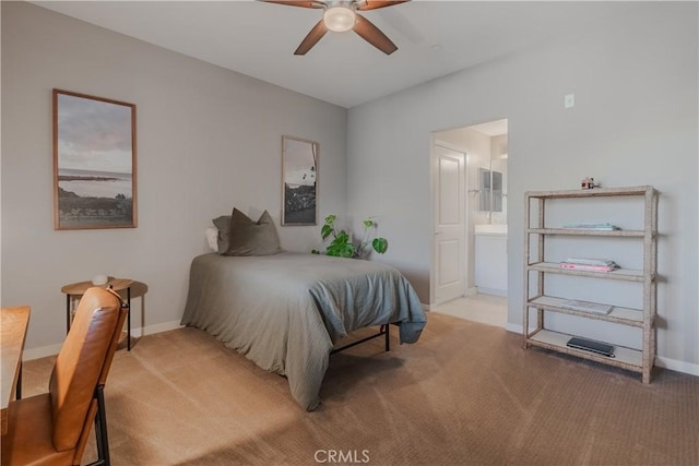 bedroom featuring ensuite bathroom, ceiling fan, and light carpet