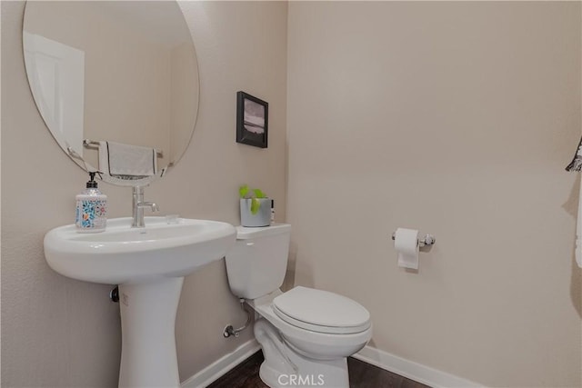 bathroom featuring hardwood / wood-style floors and toilet