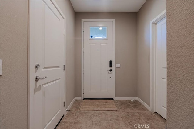 doorway with light tile patterned flooring