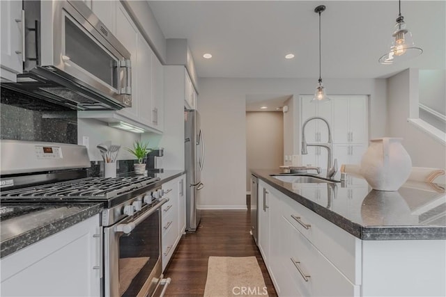 kitchen featuring pendant lighting, dark wood-type flooring, white cabinets, and stainless steel appliances