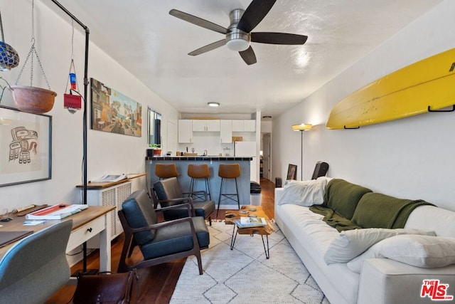 living room with ceiling fan and light wood-type flooring