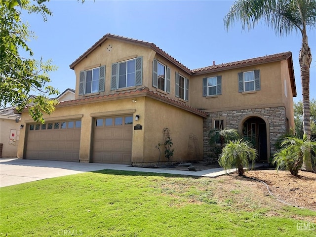 mediterranean / spanish-style house with a garage and a front lawn