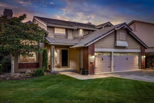 view of front facade featuring a lawn and a garage