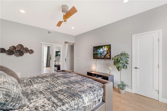 bedroom with light hardwood / wood-style floors and ceiling fan