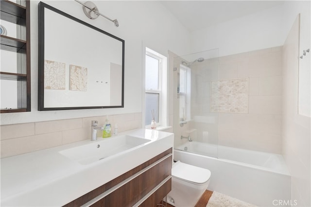 full bathroom with vanity, tasteful backsplash, tiled shower / bath, and toilet