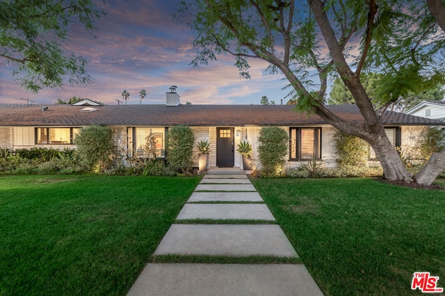 ranch-style house featuring a lawn