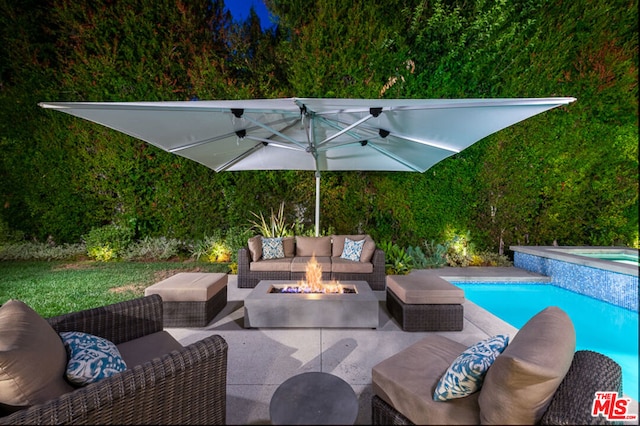 view of patio with a pool with hot tub and an outdoor living space with a fire pit