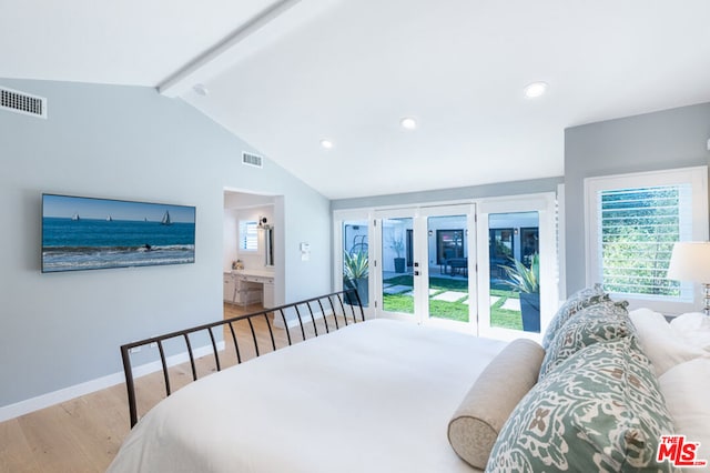 bedroom featuring light hardwood / wood-style flooring and vaulted ceiling with beams