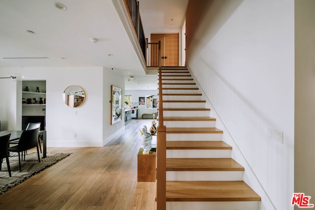 stairway with hardwood / wood-style floors