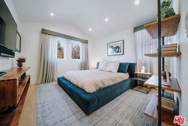 bedroom featuring vaulted ceiling and hardwood / wood-style flooring