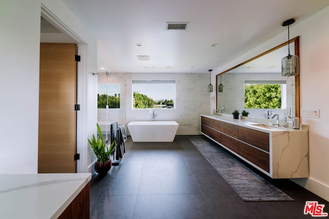 bathroom featuring a bath and vanity